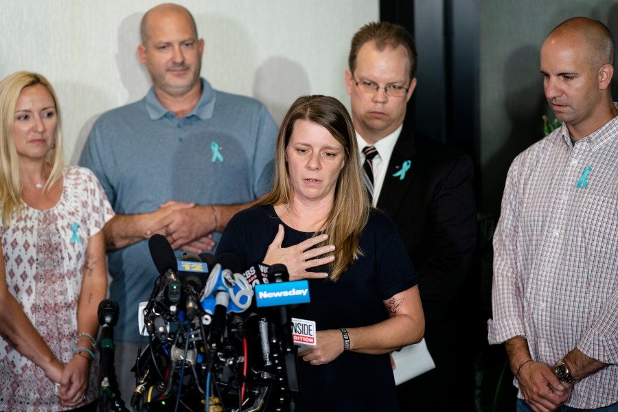 FILE - Nichole Schmidt, mother of Gabby Petito, whose death on a cross-country trip has sparked a manhunt for her boyfriend Brian Laundrie, speaks alongside, from left, Tara Petito, stepmother, Joseph Petito, father, Richard Stafford, family attorney, and Jim Schmidt, stepfather, during a news conference, Sept. 28, 2021, in Bohemia, N.Y. (AP Photo/John Minchillo, File)