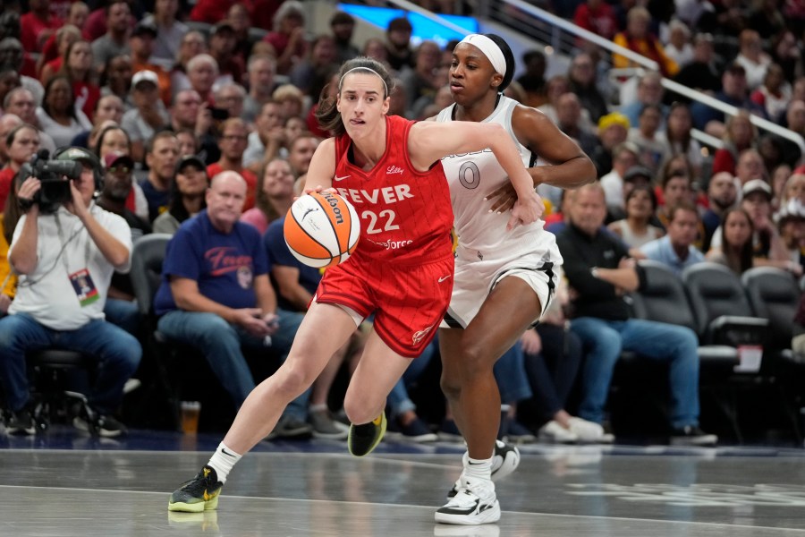 FILE - Indiana Fever's Caitlin Clark (22) goes to the basket against Las Vegas Aces' Jackie Young (0) during the first half of a WNBA basketball game, Sept. 11, 2024, in Indianapolis. (AP Photo/Darron Cummings, File)