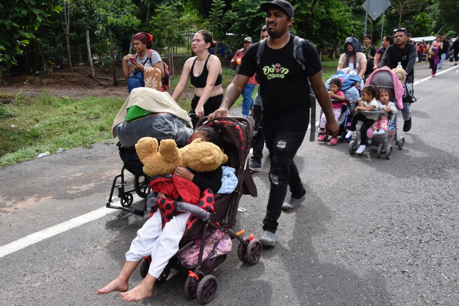 Migrants walk through Tapachula, Chiapas state, Mexico, Wednesday, Nov. 20, 2024, hoping to reach the U.S. border. (AP Photo/Edgar H. Clemente)