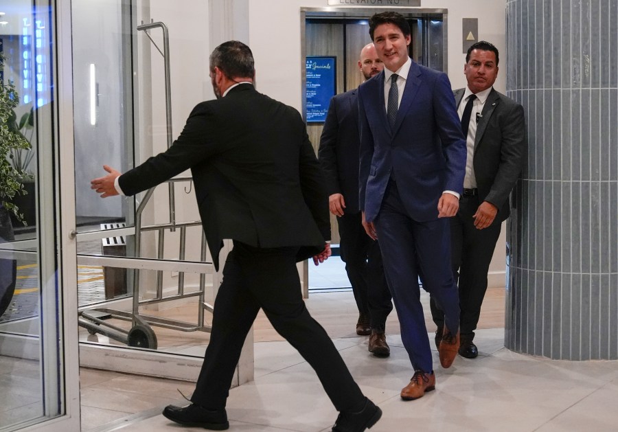 Canadian Prime Minister Justin Trudeau walks through the lobby of the Delta Hotel by Marriott, Friday, Nov. 29, 2024, in West Palm Beach, Fla. (AP Photo/Carolyn Kaster)