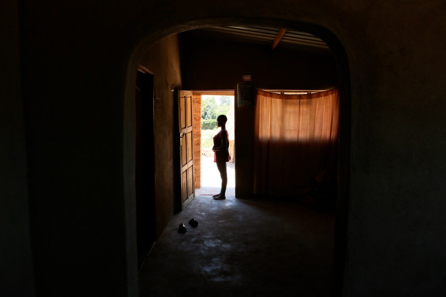 FILE - Virginia Mavhunga, a 13-year-old teenage mother, stands at the entrance of her home in Murehwa, 80 kilometres (50 miles) northeast of Zimbabwe's capital Harare, Friday, Dec. 10, 2021. (AP Photo/Tsvangirayi Mukwazhi, File)