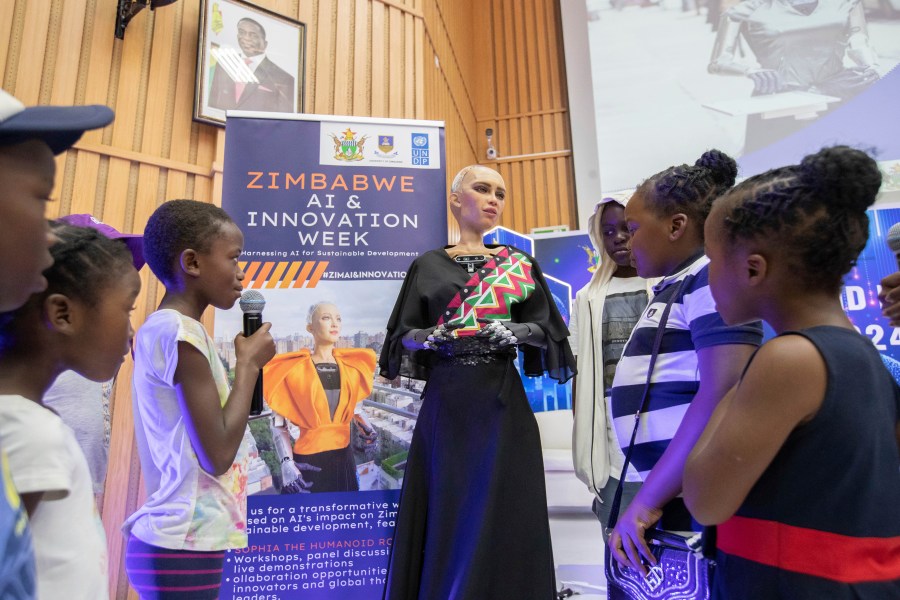 Sophia, the humanoid robot, responds to questions from children at the University of Zimbabwe, Harare, Friday, 13 Dec. 2024. (AP Photo/Aaron Ufumeli)