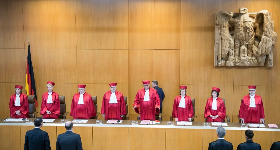 FILE - Andreas Vosskuhle, fourth from right, President of the German constitutional court announced the decision of Germany's highest court to upheld a ban on strikes by civil servants, in Karlsruhe, Germany, Tuesday, June 12, 2018. (AP Photo/Sebastian Gollnow, Pool, File)