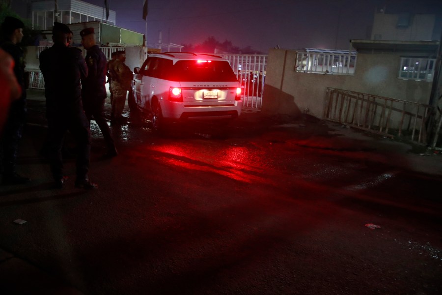 Iraqi security forces gather outside a morgue of Sheikh Zayed Hospital in Baghdad, Monday, Nov. 7, 2022, where a U.S. citizen who worked for an international aid organization was taken after he was fatally shot. (AP Photo/Hadi Mizban)