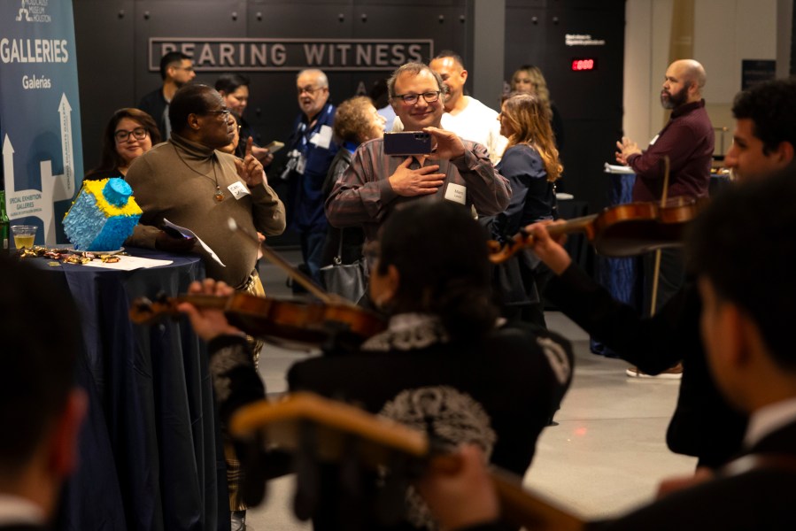 Guests enjoy a performance by Mariachi Palmeros during a Chicanukah event at Holocaust Museum Houston on Thursday, Dec. 19, 2024, in Houston. (AP Photo/Annie Mulligan)