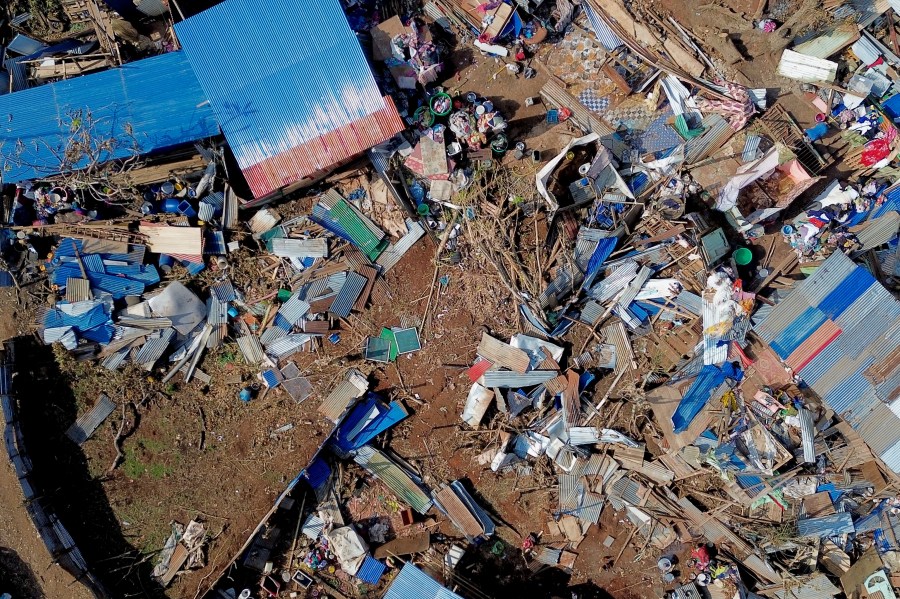 This aerial view shows destroyed homes in the Barakani, Mayotte, informal settlement, Saturday, Dec. 21, 2024. (AP Photo/Adrienne Surprenant)