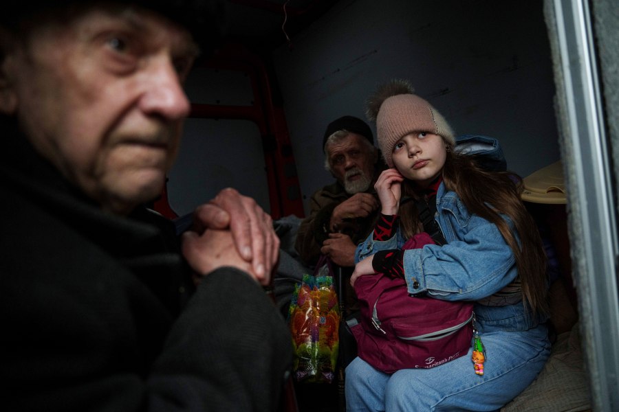 Hanna, 12, and her family sit ride inside a van during an evacuation from Pokrovsk, Ukraine, Saturday, Dec. 21, 2024. (AP Photo/Evgeniy Maloletka)