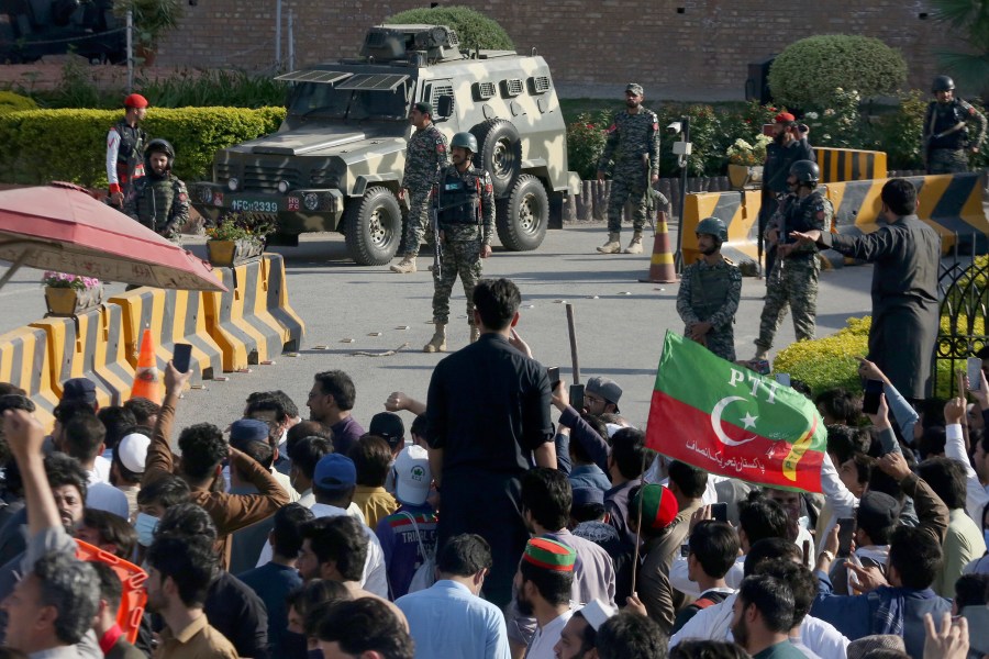 FILE - Paramilitary soldiers from Frontier Corps stand guard outside their headquarters, where supporters of Pakistan's former Prime Minister Imran Khan protest against the arrest of their leader, in Peshawar, Pakistan, Tuesday, May 9, 2023. (AP Photo/Muhammad Sajjad, File)