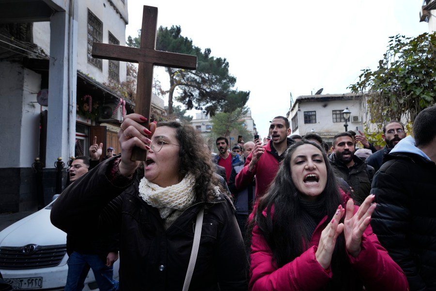 Syrian Christians shout slogans in Damascus, Syria, Tuesday, Dec. 24, 2024, as they march during a protest after a Christmas tree was set on fire in Hamah city on Sunday. (AP Photo/Hussein Malla)