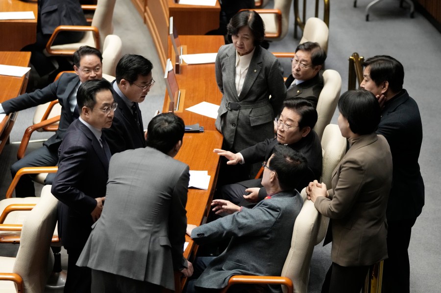 South Korea's main opposition Democratic Party leader Lee Jae-myung, third from right, talks with his party members during the plenary session at the National Assembly in Seoul, South Korea, Thursday, Dec. 26, 2024. (AP Photo/Ahn Young-joon)