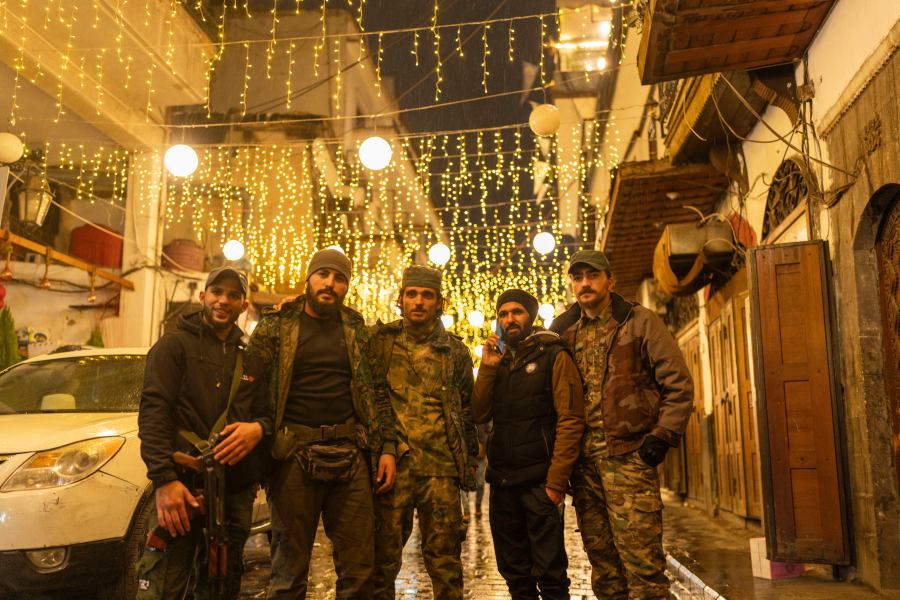 Members of the HTS rebel group that overthrew the Assad regime pose for a portrait in the ancient town of old Damascus, in Syria, Saturday, Dec. 28, 2024 (AP Photo/Mosa'ab Elshamy)